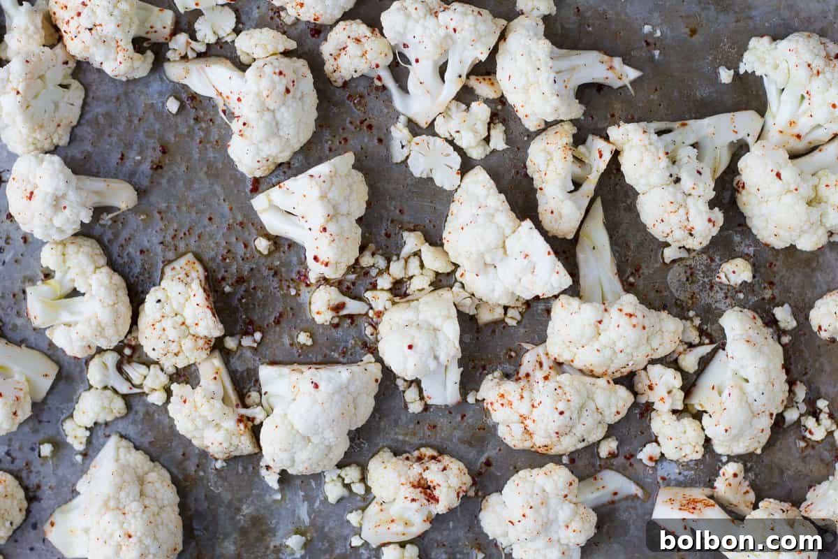 Close-up of perfectly golden-brown roasted cauliflower florets garnished with fresh parsley.