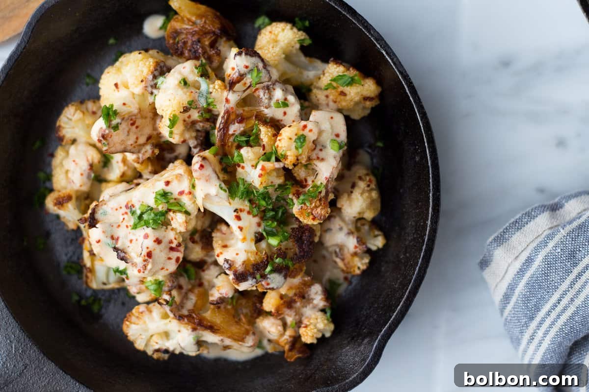 Serving roasted cauliflower with both yogurt and tahini sauces in elegant small bowls.