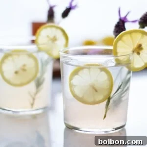 A vibrant Lavender Collins cocktail, garnished beautifully, waiting to be enjoyed.