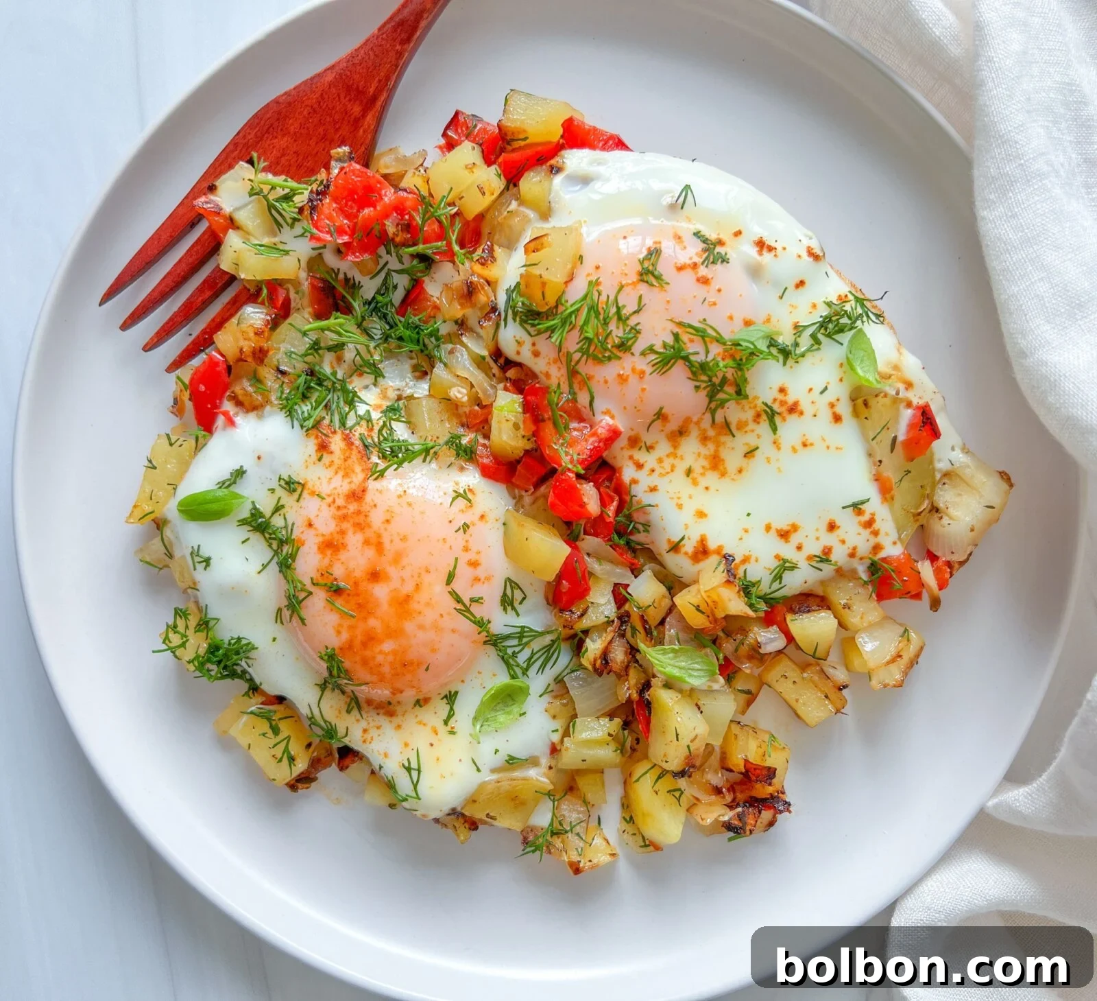 Sunrise Skillet Feast 2 Delicious and healthy breakfast skillet with eggs, potatoes, and bell peppers, garnished with fresh herbs.