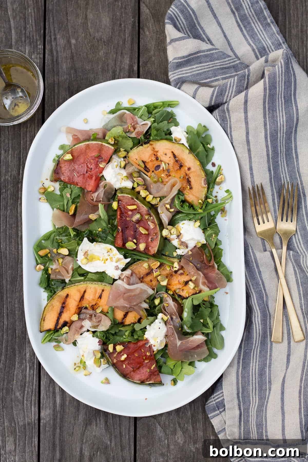 Close-up of burrata cheese and grilled melon slices, highlighting the fresh ingredients and textures