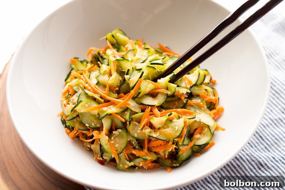 A full bowl of Sesame Carrot and Cucumber Slaw, ready to be served as a healthy, easy summer side dish.