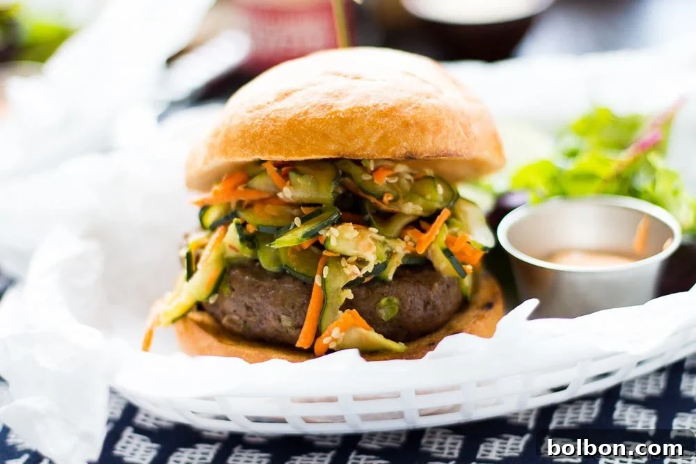 Juicy Asian Bison Burgers with vibrant toppings and sriracha aioli, ready for grilling