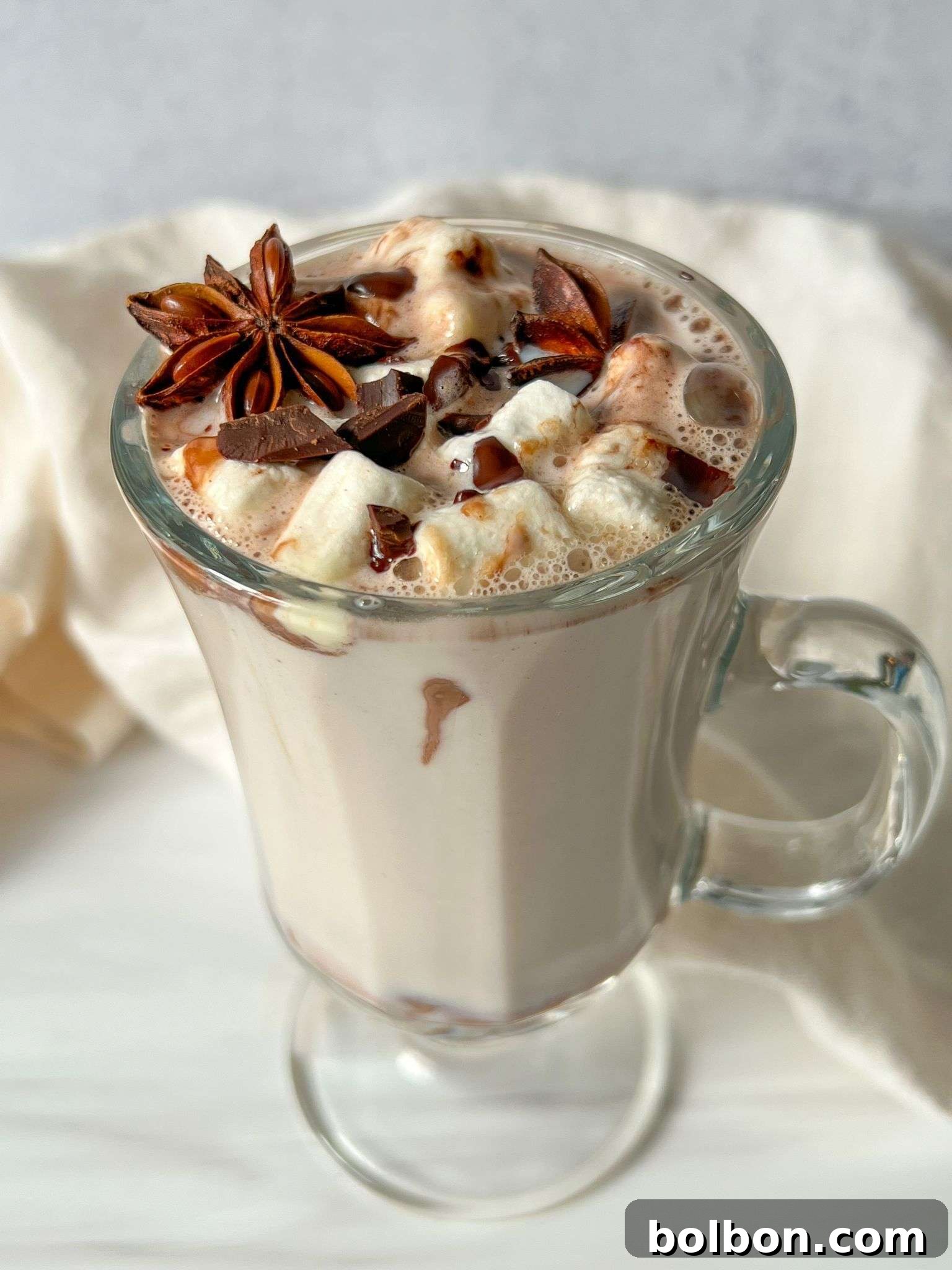 Irresistible Kinder Hot Chocolate Bombs 2 Glass mug of Kinder Hot Chocolate topped with marshmallows