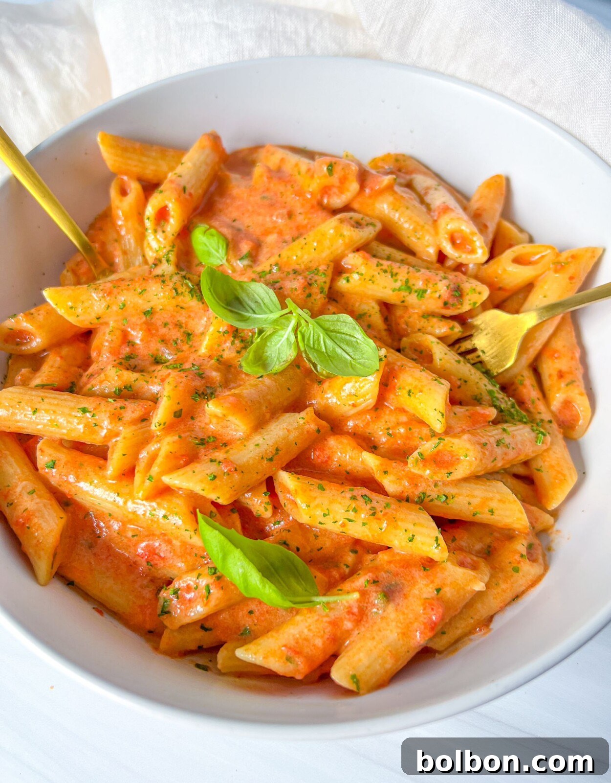 Velvety Penne Vodka 2 Penne Alla Vodka, a creamy and delicious pasta dish garnished with fresh basil.