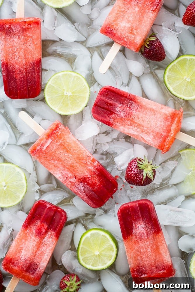 Zesty Strawberry Lime Pops 3 Close-up of vibrant homemade Strawberry Lime Popsicles in a glass
