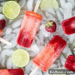 Zesty Strawberry Lime Pops 5 Vibrant Strawberry Lime Popsicles, perfectly layered and ready for summer
