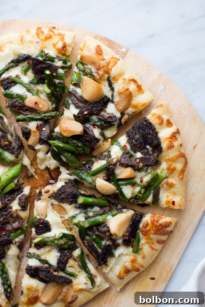 The final baked Asparagus and Morel Pizza, golden brown and bubbly, fresh out of the oven.