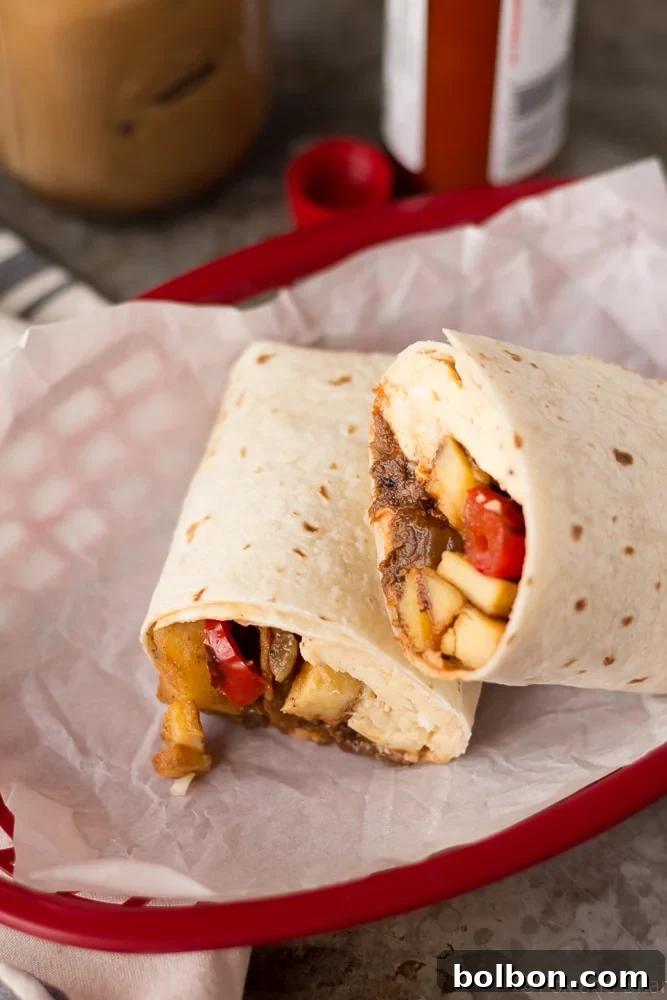 A perfectly assembled Make-Ahead Beef Breakfast Burrito, highlighting its delicious contents.