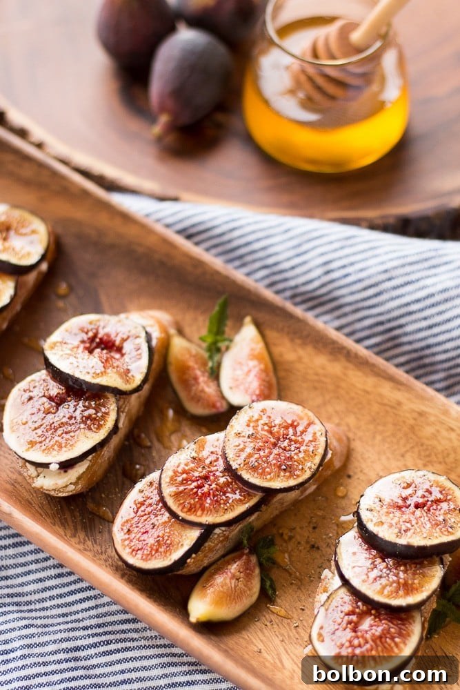 Honeyed Fig and Chevre Crostini 8 Close-up of a single Fig and Goat Cheese Crostini on a serving platter.