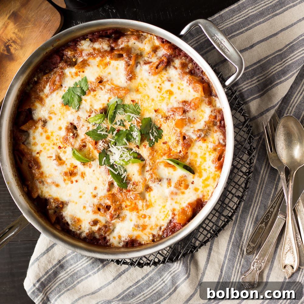 The Rich Flavors of Italian Cuisine in One Pot Close-up of bubbling, cheesy One Pot Pasta Bake with visible sausage pieces