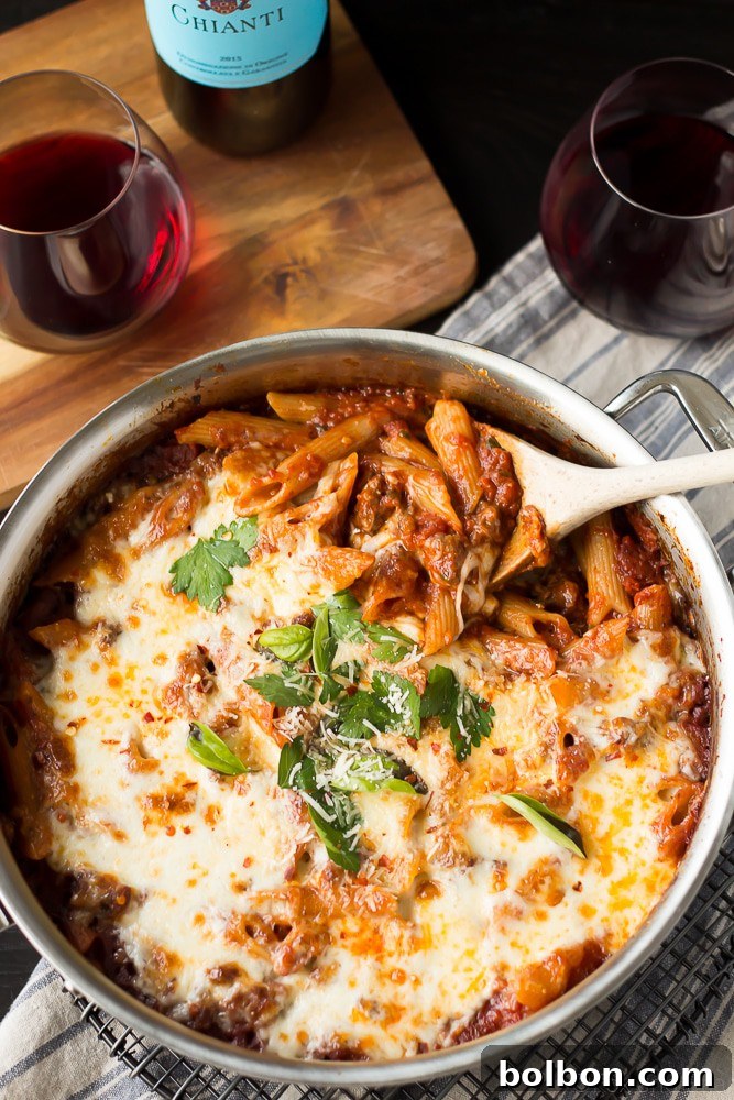 The Ultimate Easy Weeknight Dinner: One Pot Pasta Large skillet of One Pot Pasta Bake with Sausage and Wine, ready for serving