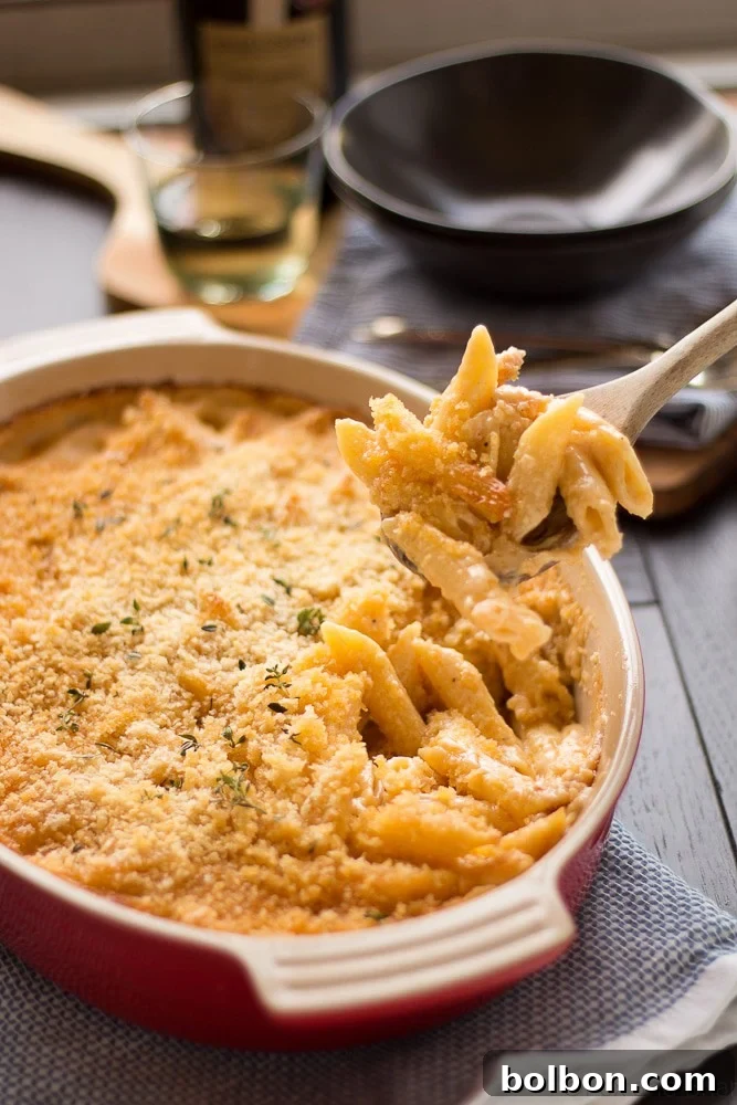 Decadent Truffle Four-Cheese Mac and Cheese 4 A generous serving of Four Cheese Truffle Mac and Cheese, garnished with fresh herbs, ready to be enjoyed.