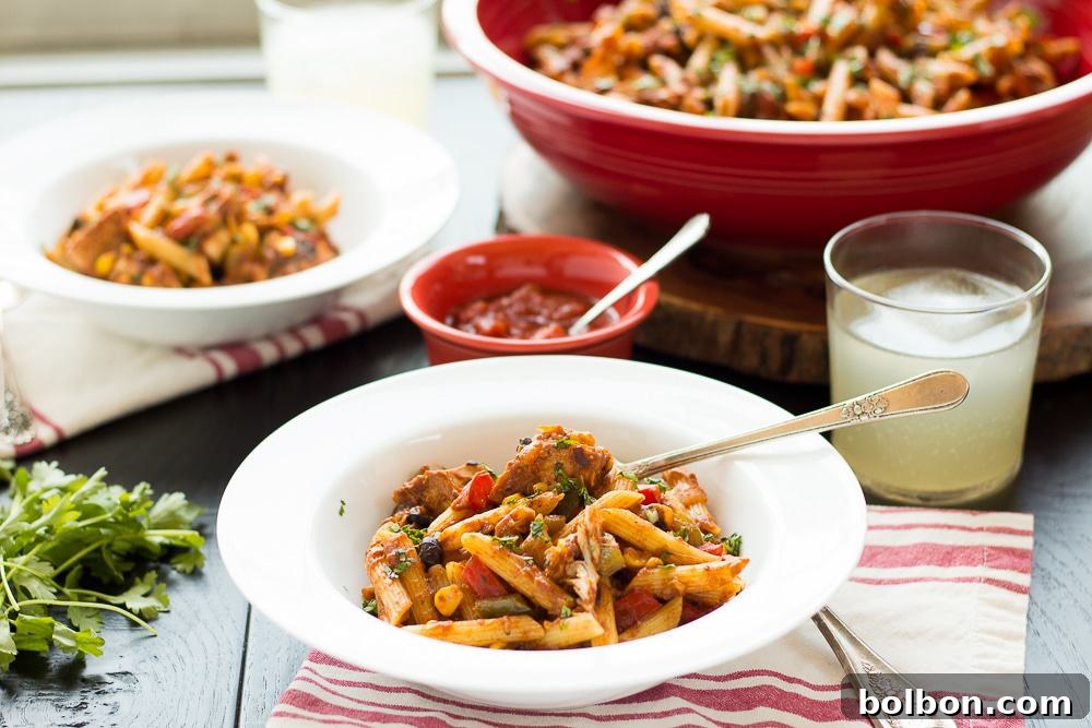 The Ultimate Chicken Taco Pasta And a Giveaway 2 A close-up shot of a creamy Chicken Taco Pasta dish garnished with fresh cilantro, ready to be served. This quick and flavorful meal is perfect for family dinners.