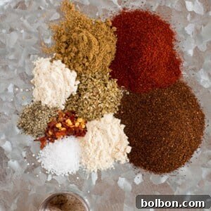 Homemade taco seasoning blend in a small white bowl, ready for use in a recipe.