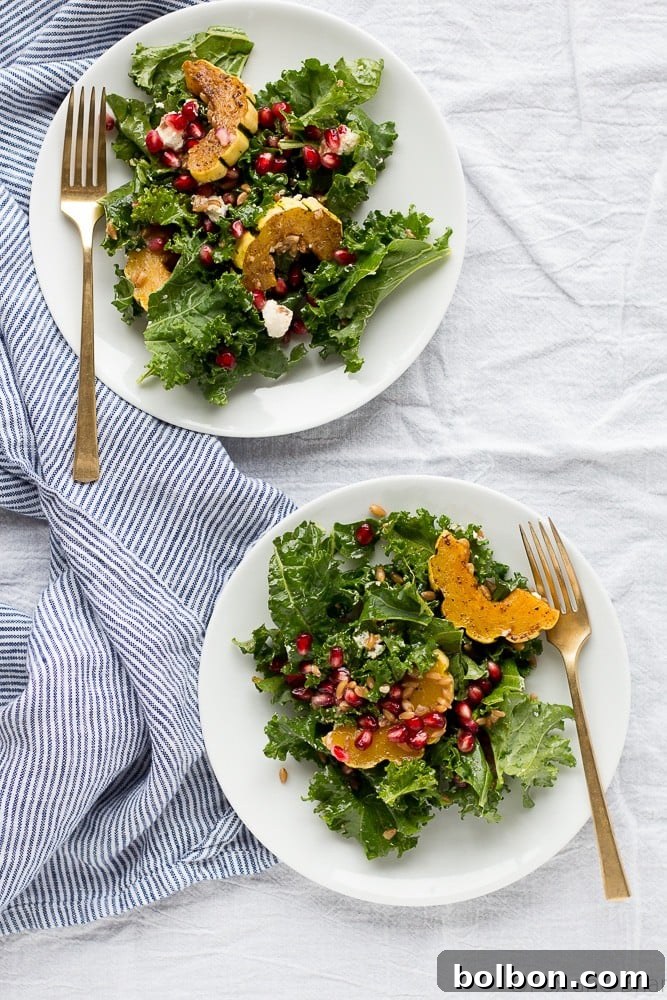 Autumn Harvest Salad served in a bowl, showcasing fresh kale, roasted squash, and glistening pomegranate arils.