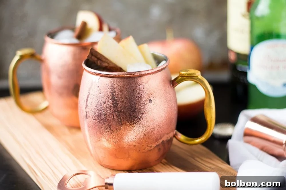 Orchard Spice Irish Mule 2 A beautifully garnished Apple Cider Irish Mule cocktail in a copper mug, perfect for autumn