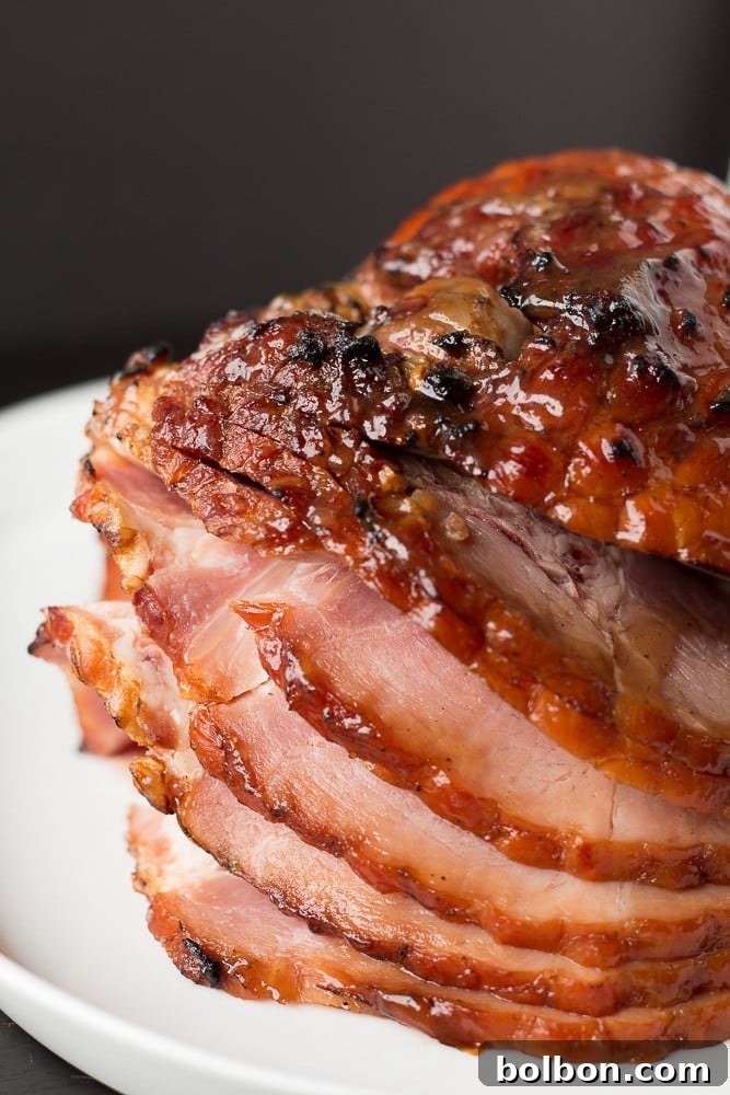 A close-up of a beautifully golden ham and cheese croissant, showing off its flaky layers and warm, inviting texture.