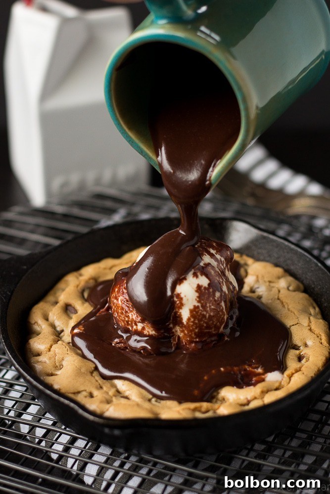 A stack of beautifully plated Chocolate Chip Cookie Blondie Skillet Sundaes, showcasing the warm cookie and melting ice cream.