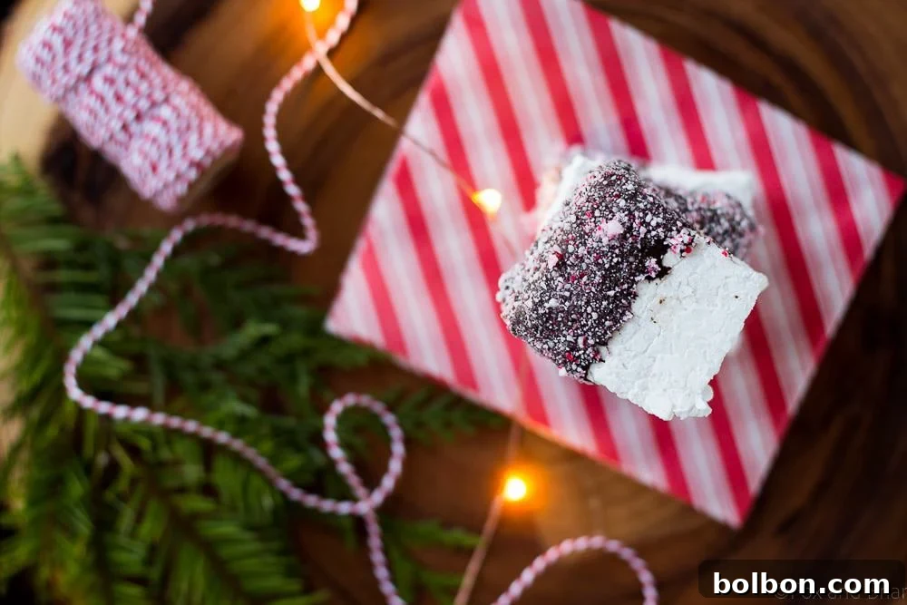 Homemade peppermint marshmallows cooling on parchment paper before being cut.