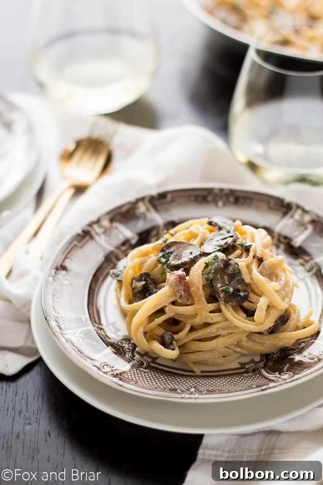 Pasta with bacon and mushrooms in a creamy white wine sauce for dinner
