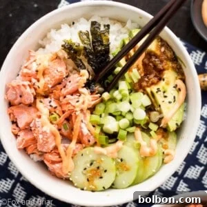 Final plated Salmon Sushi Bowl, featuring cooked salmon, fresh vegetables, sushi rice, and flavorful sauces.
