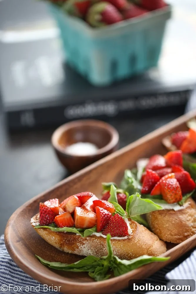 A close-up of a serving of Strawberry Chambord Whipped Cheese Toasts, highlighting the texture and fresh ingredients.