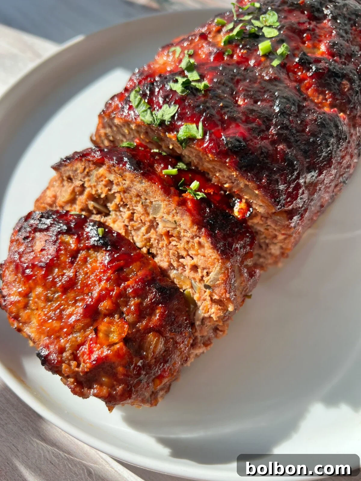 Crispy Air Fryer Meatloaf 2 A perfectly cooked Air Fryer Meatloaf, sliced and ready to serve, showcasing a juicy interior and a golden-brown, crispy exterior.