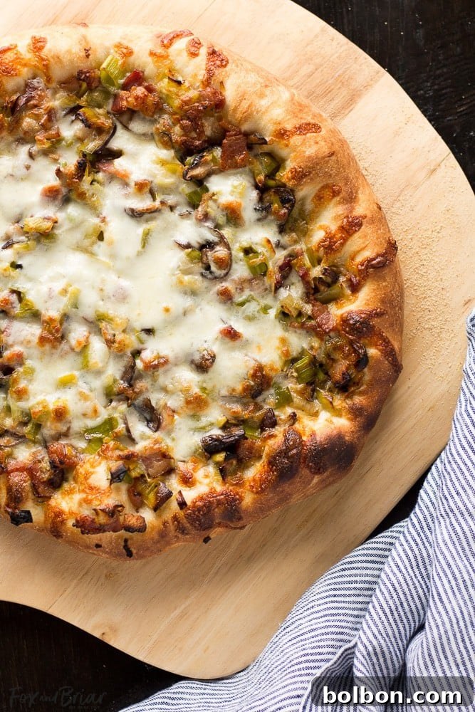 Leek, Bacon, and Mushroom Pizza on a wooden board