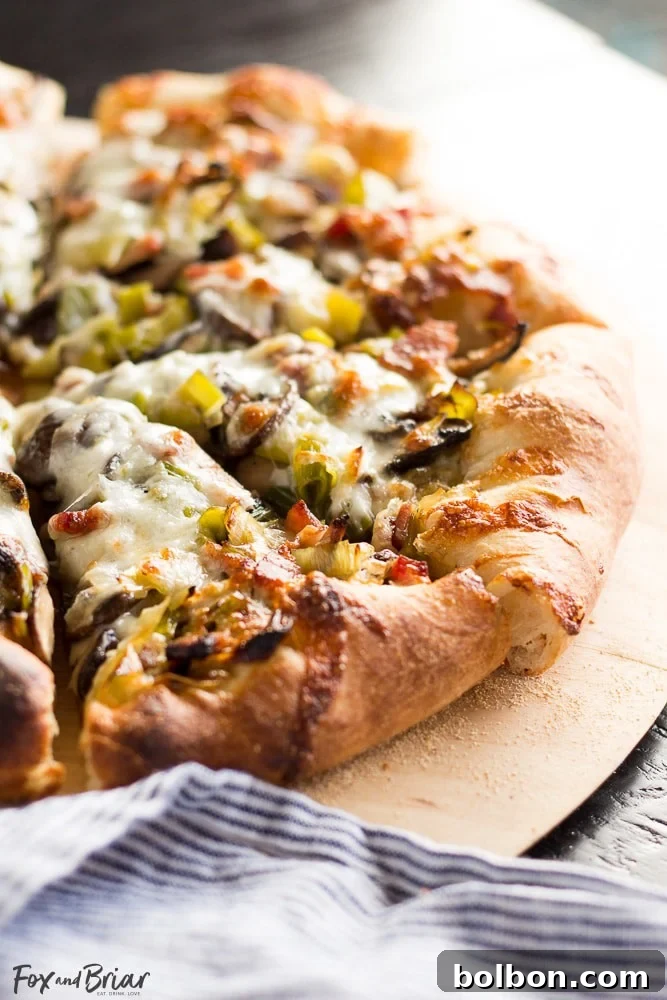 Serving slice of Leek, Bacon, and Mushroom Pizza