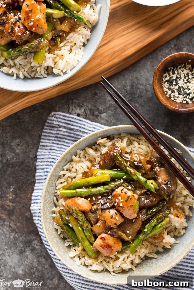 Vibrant Ginger Chicken Asparagus Stir-Fry 7 Delicious Ginger Chicken Asparagus Stir Fry served with rice and garnished with sesame seeds and green onions