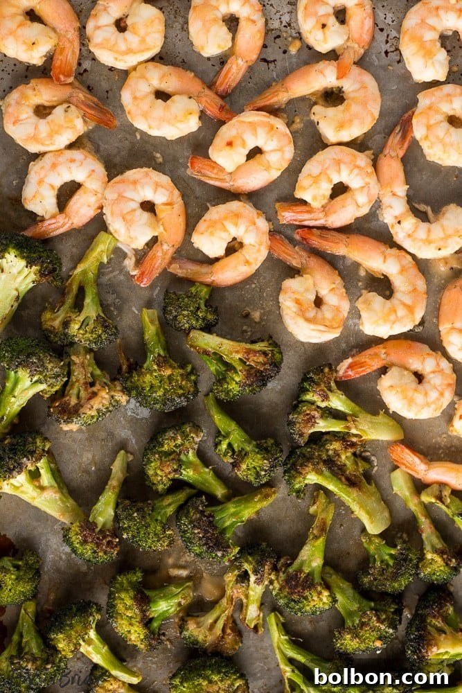 One-Pan Peanut Shrimp and Broccoli 3 Close-up of roasted broccoli and shrimp tossed in peanut sauce on a sheet pan
