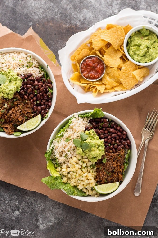 An overhead shot showcasing the fresh ingredients for Slow Cooker Beef Burrito Bowls, including shredded beef, rice, beans, corn, and greens.
