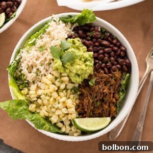 A beautifully garnished Slow Cooker Beef Burrito Bowl ready to be enjoyed.