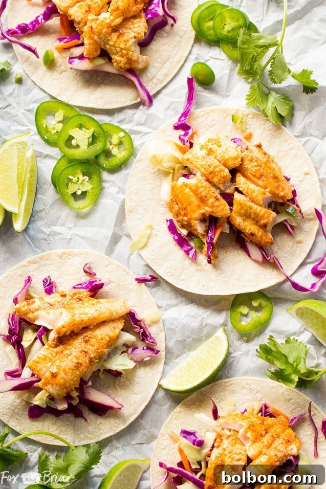 A close-up of a Chipotle Lime Fish Taco, perfectly capturing the crispy edges of the tortilla, the flaky fish, and the vibrant toppings.