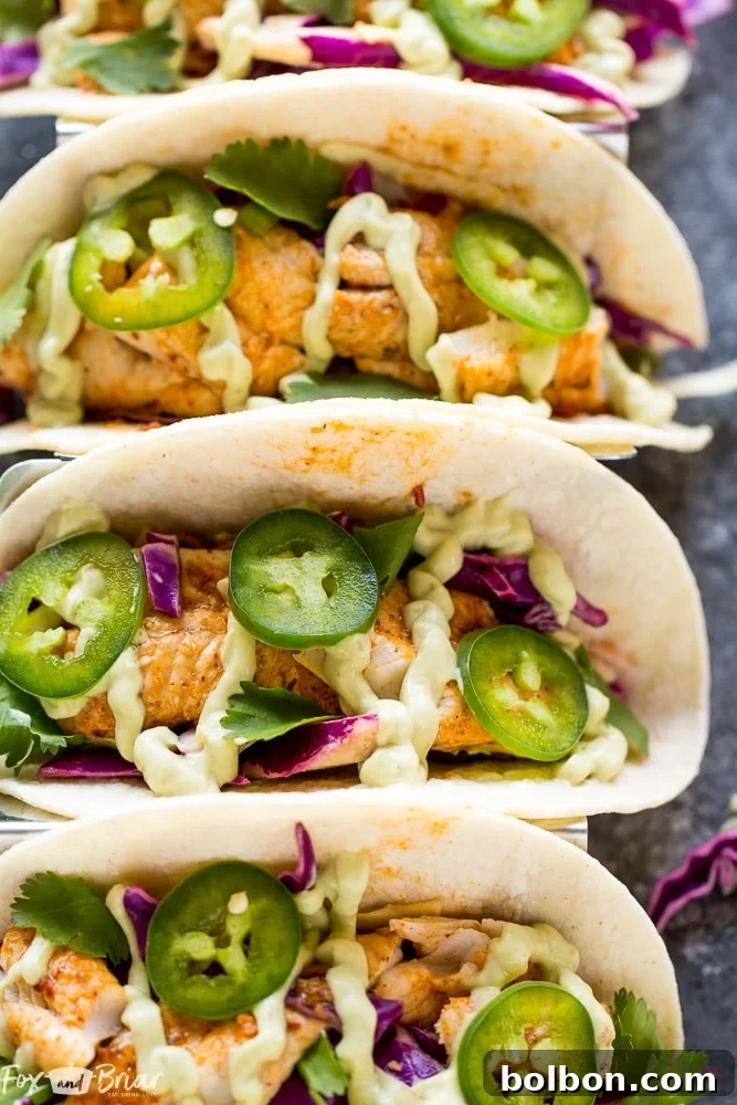 A vibrant close-up of the fresh ingredients for the crunchy jalapeno lime slaw, including sliced cabbage, diced jalapenos, and lime wedges.