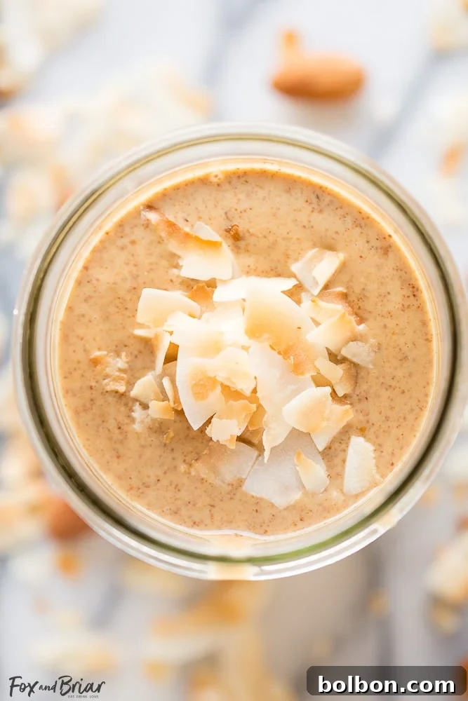 Toasted Coconut Almond Butter spread on a slice of apple, showcasing its versatility as a healthy dip.