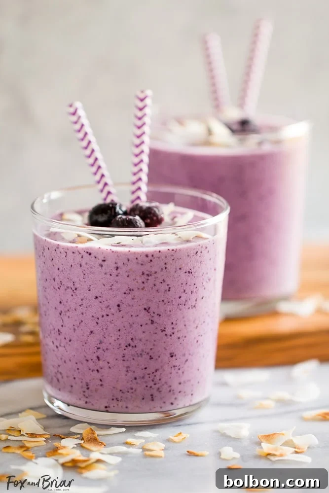 A refreshing Blueberry Banana Coconut Smoothie in a glass, with a garnish, ready to be enjoyed.