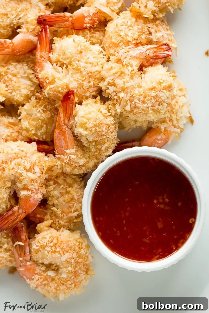 Restaurant-Quality Baked Coconut Shrimp at Home 5 A plate of golden baked coconut shrimp, perfectly crispy and ready to eat.