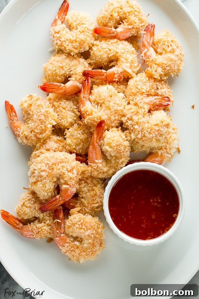 Restaurant-Quality Baked Coconut Shrimp at Home 7 A generous serving of crispy, golden baked coconut shrimp on a platter, ready to be enjoyed.