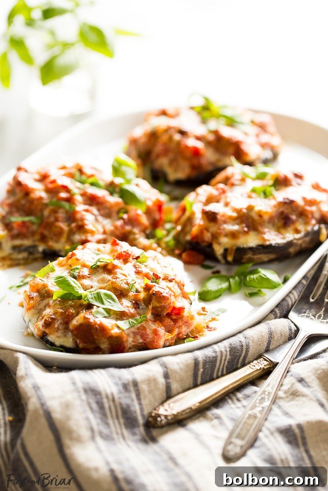 Gourmet Sausage Stuffed Portobellos 5 Hands preparing portobello mushrooms by removing the stems and gills before stuffing.