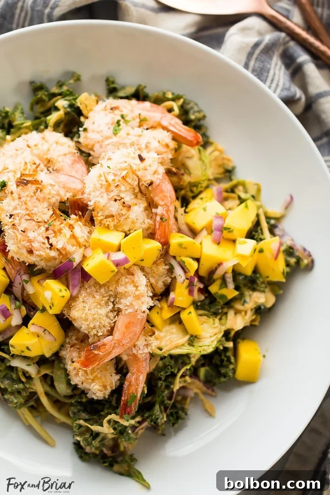 Crispy Coconut Shrimp Salad with Zesty Mango Salsa and Creamy Peanut Dressing 3 Close-up of freshly prepared Coconut Shrimp Salad on a plate
