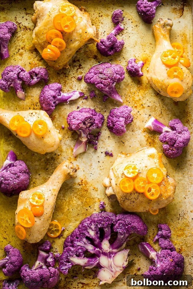 Golden Roasted Chicken and Cauliflower with Olive Oil 6 Close-up of roasted chicken and kumquats on a baking sheet, glistening with glaze