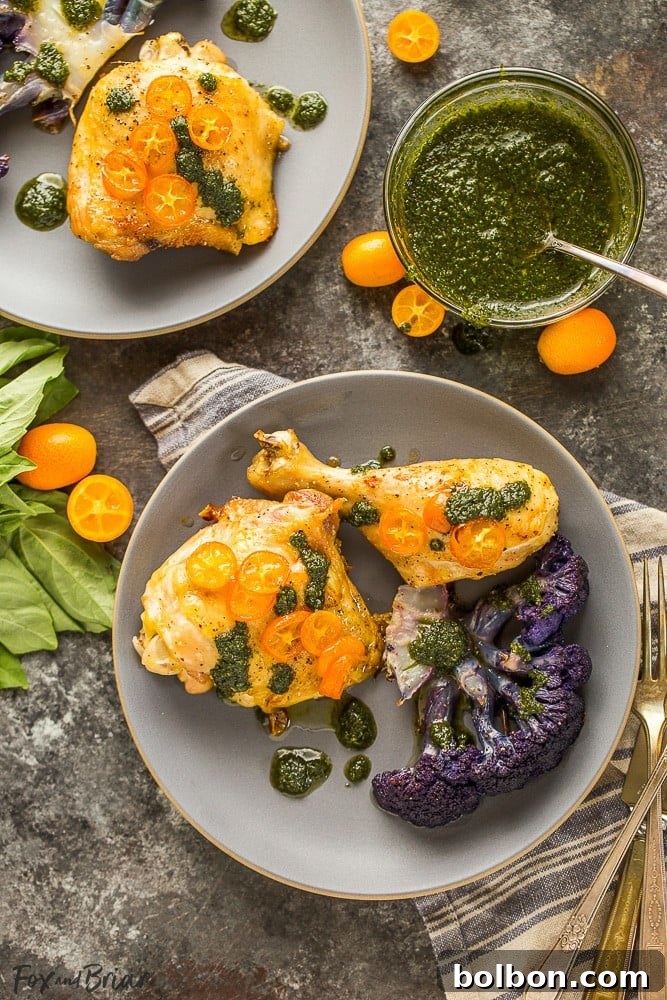 Golden Roasted Chicken and Cauliflower with Olive Oil 9 A beautifully arranged serving of roasted chicken, purple cauliflower, and kumquats with a fresh basil garnish