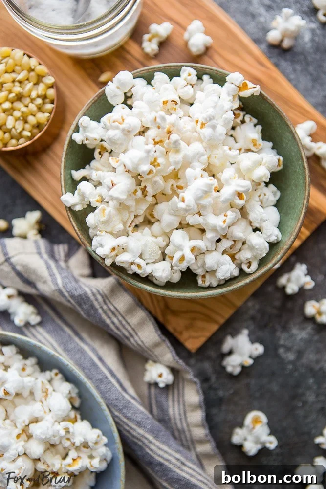 A close-up shot of freshly popped, perfectly seasoned truffle popcorn in a rustic bowl, ready for snacking. | gourmet popcorn recipe | truffle snack idea | easy movie night food