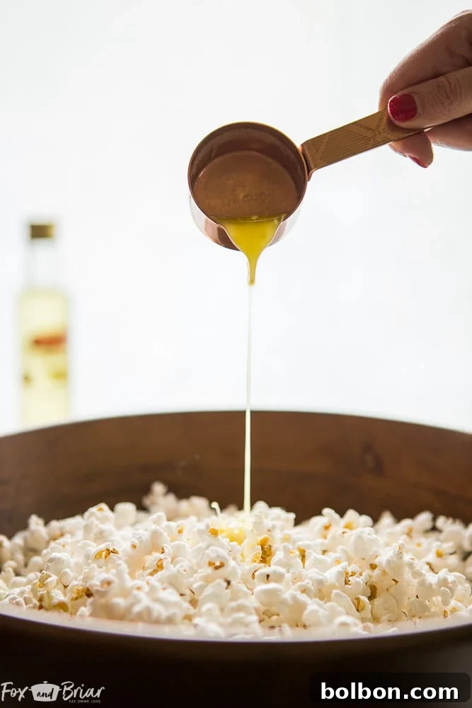 Meghan holding a large bowl of homemade truffle popcorn, showcasing its fluffy texture and inviting appeal. | homemade truffle popcorn | snack recipes | popcorn addiction
