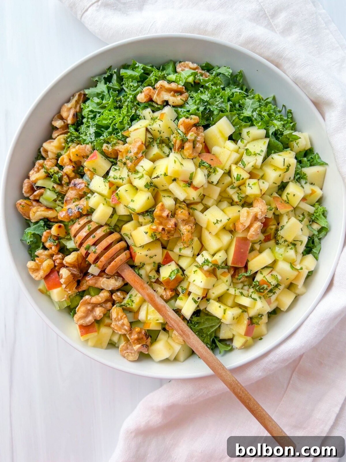 The Adele Salad, a vibrant mix of chopped greens, apples, walnuts, and celery, with a light lemon dressing.