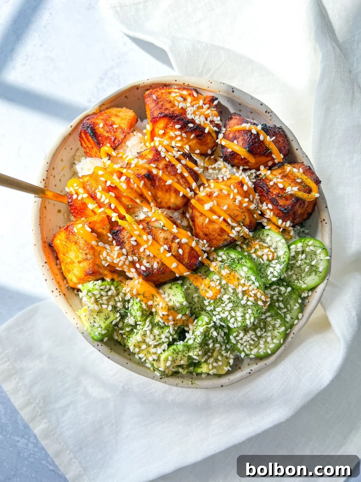 Flavorful Salmon Rice Bowl 2 Salmon Rice Bowl with crispy salmon, avocado, cucumber, rice, and spicy mayo