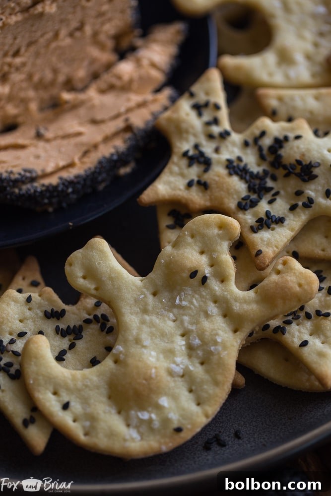 Spooktacular Surprise Crackers 6 A trio of bat and ghost Parmesan crackers artfully placed on a Halloween themed cheese board with a dark backdrop