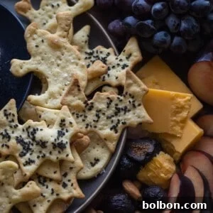 Finished Bat and Ghost Halloween Crackers on a cooling rack, golden and crispy
